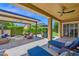 Expansive covered patio with cozy seating, outdoor dining, and a stylish fire pit, perfect for relaxation at 1673 E Laddoos Ave, Queen Creek, AZ 85140