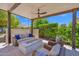 Covered patio featuring a comfortable seating area with a fire pit and outdoor ceiling fan at 1673 E Laddoos Ave, Queen Creek, AZ 85140