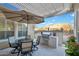 Inviting patio with a dining set, a built-in BBQ, and a serene outdoor space at 1673 E Laddoos Ave, Queen Creek, AZ 85140