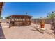 Expansive backyard featuring a cozy gazebo, fire pit, and easy-to-maintain gravel landscaping at 18217 N 34Th Ave, Phoenix, AZ 85053