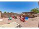 Inviting backyard with gravel landscaping, fire pit, and seating area, ideal for outdoor gatherings at 18217 N 34Th Ave, Phoenix, AZ 85053