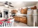 A warm kitchen features wooden cabinets, stainless appliances, and an adjacent dining area for easy meal service at 18217 N 34Th Ave, Phoenix, AZ 85053