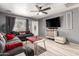A comfortable living room featuring a ceiling fan, television, and stylish decor, perfect for relaxation and entertainment at 18217 N 34Th Ave, Phoenix, AZ 85053