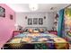 A cozy primary bedroom showcases colorful bedding, unique wall art, and a calming, creative space at 18217 N 34Th Ave, Phoenix, AZ 85053