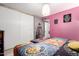 This is a cozy primary bedroom featuring colorful bedding, a closet, and a calming, creative space at 18217 N 34Th Ave, Phoenix, AZ 85053