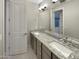 Bathroom vanity with double sinks, granite countertop, and ample cabinet storage at 18389 W Long Lake Rd, Goodyear, AZ 85338
