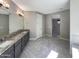 Large bathroom featuring granite countertops, tiled floors, and a double sink vanity at 18389 W Long Lake Rd, Goodyear, AZ 85338