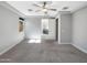 Neutral bedroom with ensuite bathroom access, neutral walls, and a ceiling fan at 18389 W Long Lake Rd, Goodyear, AZ 85338