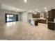 Open layout features kitchen with stainless steel appliances and a living space with sliding glass doors at 18389 W Long Lake Rd, Goodyear, AZ 85338