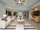 Bright open concept living room with high ceilings, modern furnishings, and an adjacent open-plan kitchen at 18389 W Long Lake Rd, Goodyear, AZ 85338