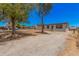 Well-maintained home featuring a clean gravel driveway, modern windows, and mature trees at 201 S 91St St, Mesa, AZ 85208