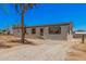 Charming single-story home featuring grey siding, dark shutters, and a small front yard at 201 S 91St St, Mesa, AZ 85208