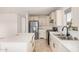 Bright kitchen boasts new appliances, white cabinets, and a modern sink with stylish fixtures at 201 S 91St St, Mesa, AZ 85208