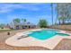 Backyard view featuring a refreshing pool with a diving board surrounded by lush landscaping at 2607 E Mercer Ln, Phoenix, AZ 85028