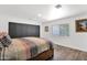 Bedroom with luxury vinyl flooring, neutral paint, black closet doors, and a window at 2607 E Mercer Ln, Phoenix, AZ 85028