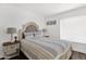 Comfortable bedroom with a queen bed, side tables with lamps, and a window, designed to be restful and pleasing at 2607 E Mercer Ln, Phoenix, AZ 85028