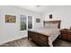 Cozy bedroom with a wood-frame bed, wood-look flooring, and a bright window, offering a comfortable and inviting space at 2607 E Mercer Ln, Phoenix, AZ 85028