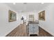 Bright dining room with hardwood floors and view into living and kitchen areas at 2607 E Mercer Ln, Phoenix, AZ 85028