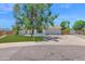 Charming single-story home featuring a well-maintained lawn, mature shade trees, and a two-car garage at 2607 E Mercer Ln, Phoenix, AZ 85028