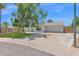 Charming single-story home featuring a well-maintained lawn, mature shade trees, and a two-car garage at 2607 E Mercer Ln, Phoenix, AZ 85028