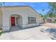 Inviting front exterior featuring a red front door, arched entryway, and fresh landscaping at 2607 E Mercer Ln, Phoenix, AZ 85028
