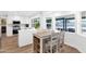 Bright kitchen featuring white cabinetry, stainless steel appliances, and large windows overlooking the backyard at 2607 E Mercer Ln, Phoenix, AZ 85028