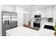 Well-lit kitchen featuring stainless steel appliances, white cabinets, and quartz countertop at 2607 E Mercer Ln, Phoenix, AZ 85028