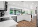 Bright kitchen featuring white cabinetry, quartz countertops, stainless appliances, and a large window overlooking the pool at 2607 E Mercer Ln, Phoenix, AZ 85028