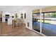 Open-concept kitchen and dining area with views of the outdoor patio and pool area through sliding glass doors at 2607 E Mercer Ln, Phoenix, AZ 85028