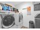 Functional laundry room with modern washer and dryer, and storage options, offering a practical space for home tasks at 2607 E Mercer Ln, Phoenix, AZ 85028