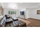 Stylish living room with comfortable seating, modern entertainment center, and ample natural light at 2607 E Mercer Ln, Phoenix, AZ 85028