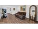 Comfortable living room with an oversized couch, paintings, and luxury vinyl flooring at 2607 E Mercer Ln, Phoenix, AZ 85028