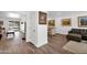 Open-concept living area seamlessly connecting to an adjacent room, enhanced by elegant hardwood floors at 2607 E Mercer Ln, Phoenix, AZ 85028
