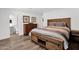 Main bedroom featuring an ensuite bathroom, a dresser, and luxury vinyl flooring at 2607 E Mercer Ln, Phoenix, AZ 85028