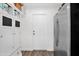 Mud room with stainless fridge, white cabinets and drawers, and white subway tile backsplash at 2607 E Mercer Ln, Phoenix, AZ 85028