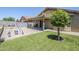 Backyard featuring a covered patio area, beautiful landscaping, and a swing set for outdoor fun and relaxation at 2717 W Bowker St, Phoenix, AZ 85041