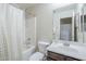 Bright bathroom featuring a shower-tub combo, toilet, vanity, and large mirror for a functional and stylish space at 2717 W Bowker St, Phoenix, AZ 85041