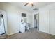 Carpeted bedroom with a vanity, ceiling fan, closet and adjacent bathroom provides comfort and convenience at 2717 W Bowker St, Phoenix, AZ 85041