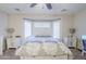 Bright bedroom features bay windows, ceiling fan, and white furniture at 2717 W Bowker St, Phoenix, AZ 85041