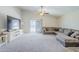 Bright living room featuring neutral carpet, a ceiling fan, and a large sectional sofa at 2717 W Bowker St, Phoenix, AZ 85041