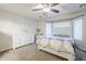 Bedroom featuring a neutral color scheme, ceiling fan, and matching dresser and nightstand at 2717 W Bowker St, Phoenix, AZ 85041