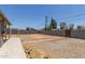 Open backyard with gravel, block wall, and defined planting bed ready for your design at 2749 W San Juan Ave, Phoenix, AZ 85017