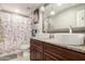 Bathroom featuring dual sinks, granite countertops, and stylish lighting at 2749 W San Juan Ave, Phoenix, AZ 85017