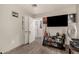 Bedroom with modern gray walls, mounted TV, light wood flooring, and wall decor at 2749 W San Juan Ave, Phoenix, AZ 85017