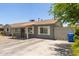 Home's charming exterior with fresh paint, gated driveway, and low maintenance front yard at 2749 W San Juan Ave, Phoenix, AZ 85017