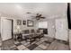 Living room featuring gray sofa, unique decor, a ceiling fan, and decorative lighting at 2749 W San Juan Ave, Phoenix, AZ 85017