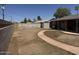 A home's expansive backyard offers ample space with landscaping features at 3006 W Stella Ln, Phoenix, AZ 85017