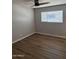 Spacious bedroom boasts updated flooring and a large window for plenty of natural light at 3006 W Stella Ln, Phoenix, AZ 85017