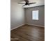 Spacious bedroom boasts updated flooring and a large window for plenty of natural light at 3006 W Stella Ln, Phoenix, AZ 85017