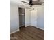 This bedroom offers modern ceiling fan, wood-look floors and a closet for a stylish and functional living space at 3006 W Stella Ln, Phoenix, AZ 85017
